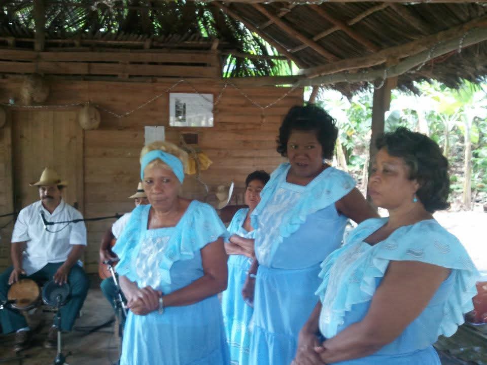 Community performers in blue dresses during the DC Casineros visit to Baracoa