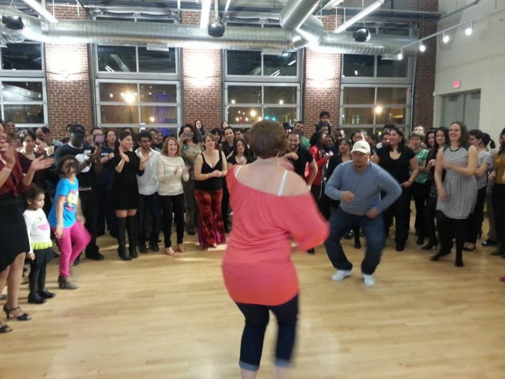 Dancers taking turns in the center of a circle at a DC Casineros Cuban dance social