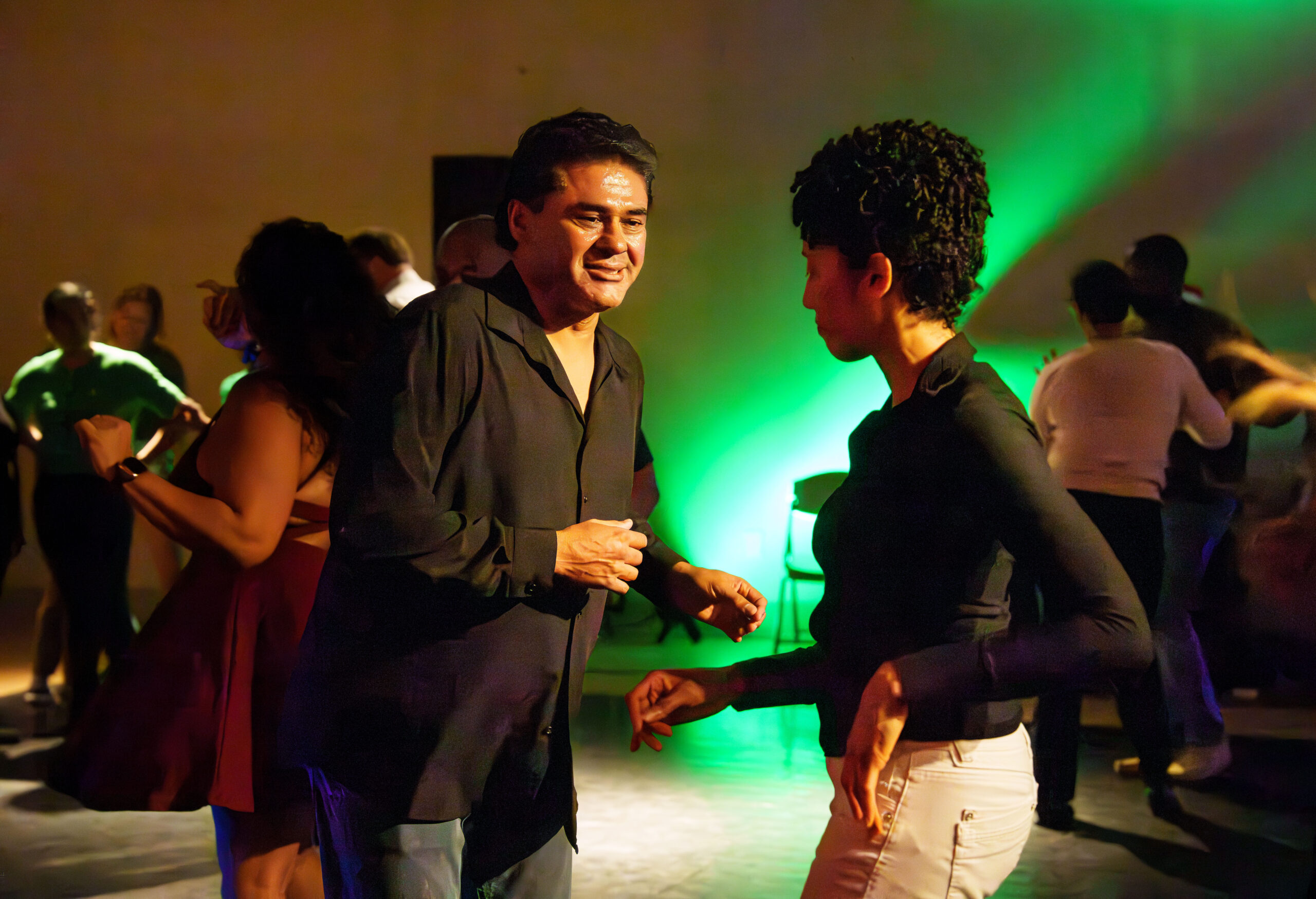 Partners dance together during the December 2025 DC Casineros Cuban Dance Social.