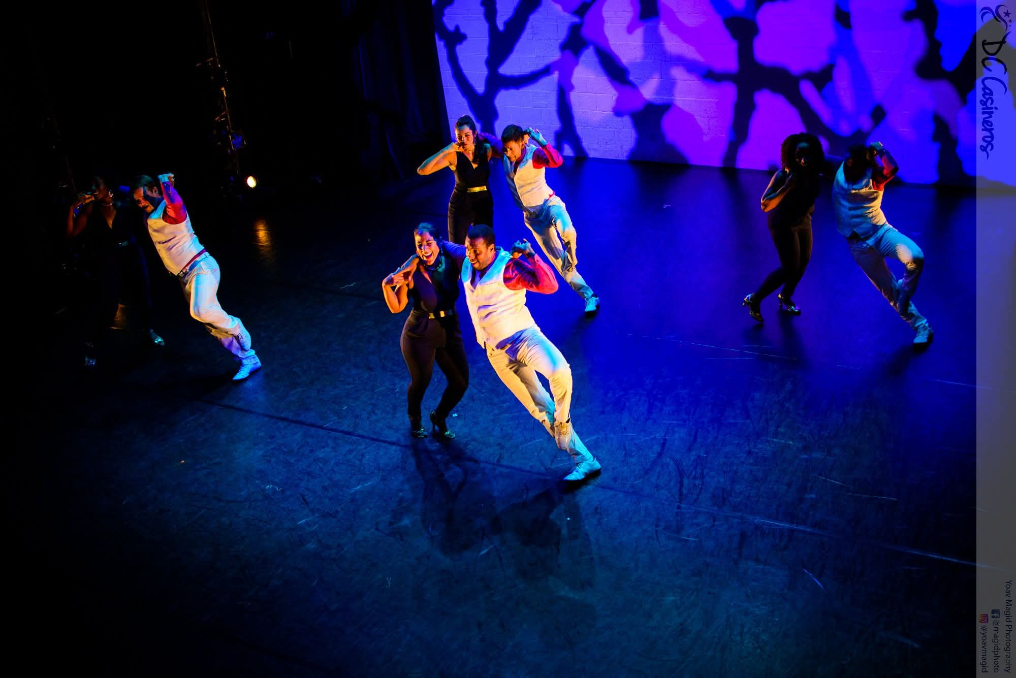DC Casineros ensemble performing under blue stage lights
