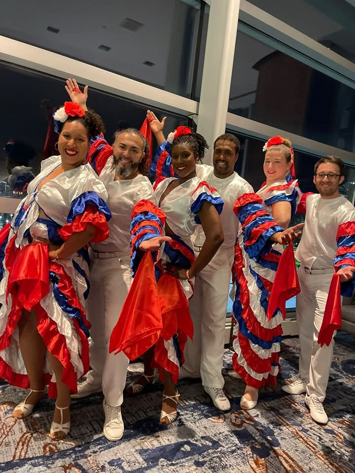 Six DC Casineros dancers posing in red, blue and white performance costumes