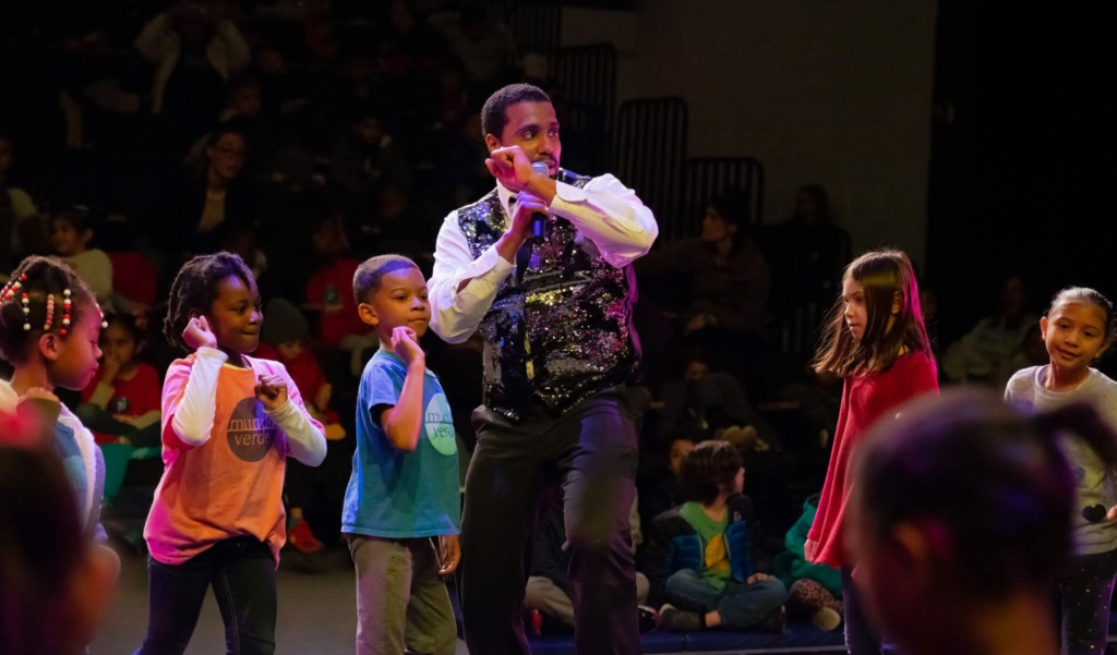 Children joining a movement activity with a DC Casineros teaching artist.