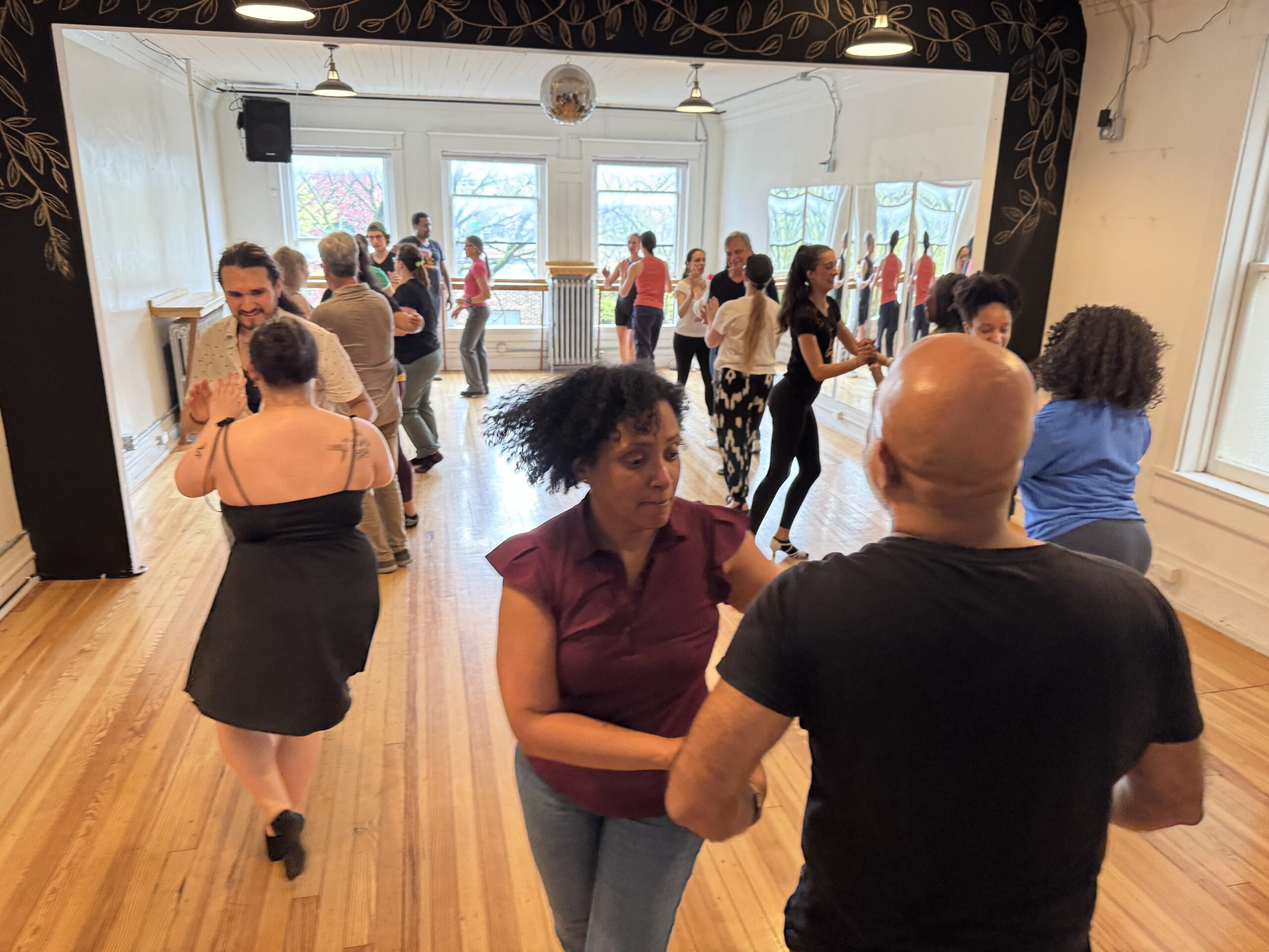 Participants practicing partner dance in a studio at the DC Casineros Ithaca weekend
