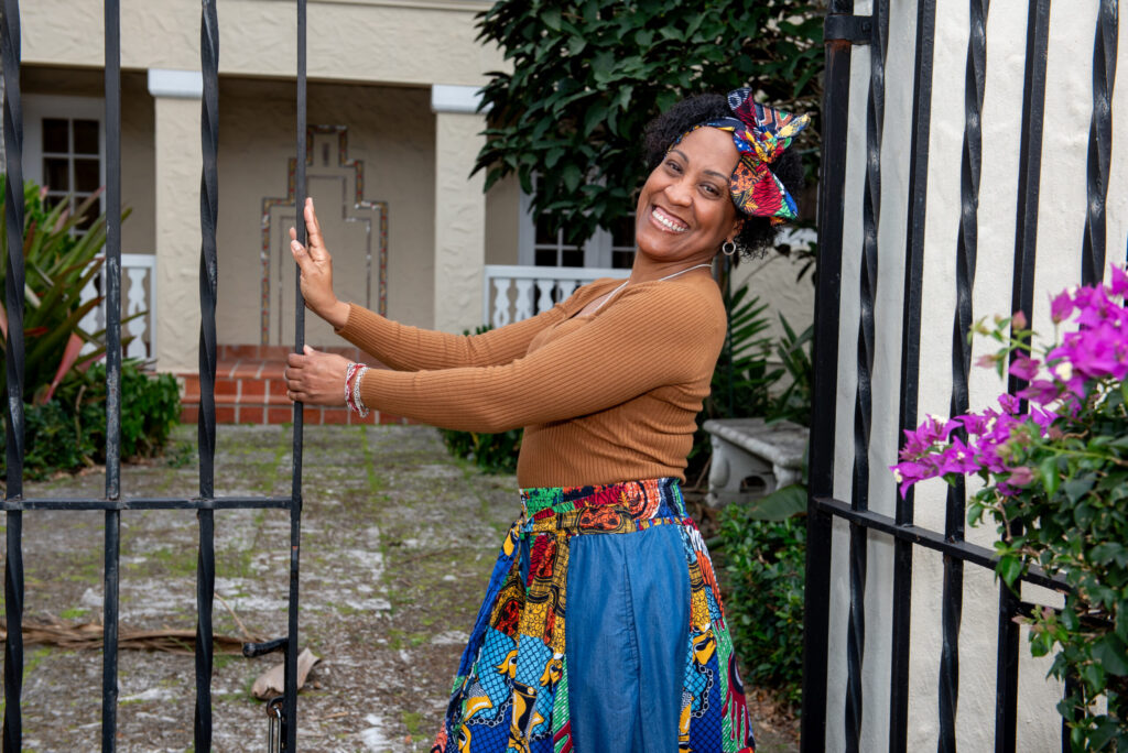 Marisol Blanco smiling beside a garden gate