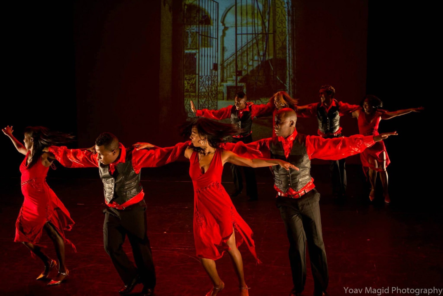 An ensemble in red costumes performs in Somos Cubanos at Dance Place in 2015.